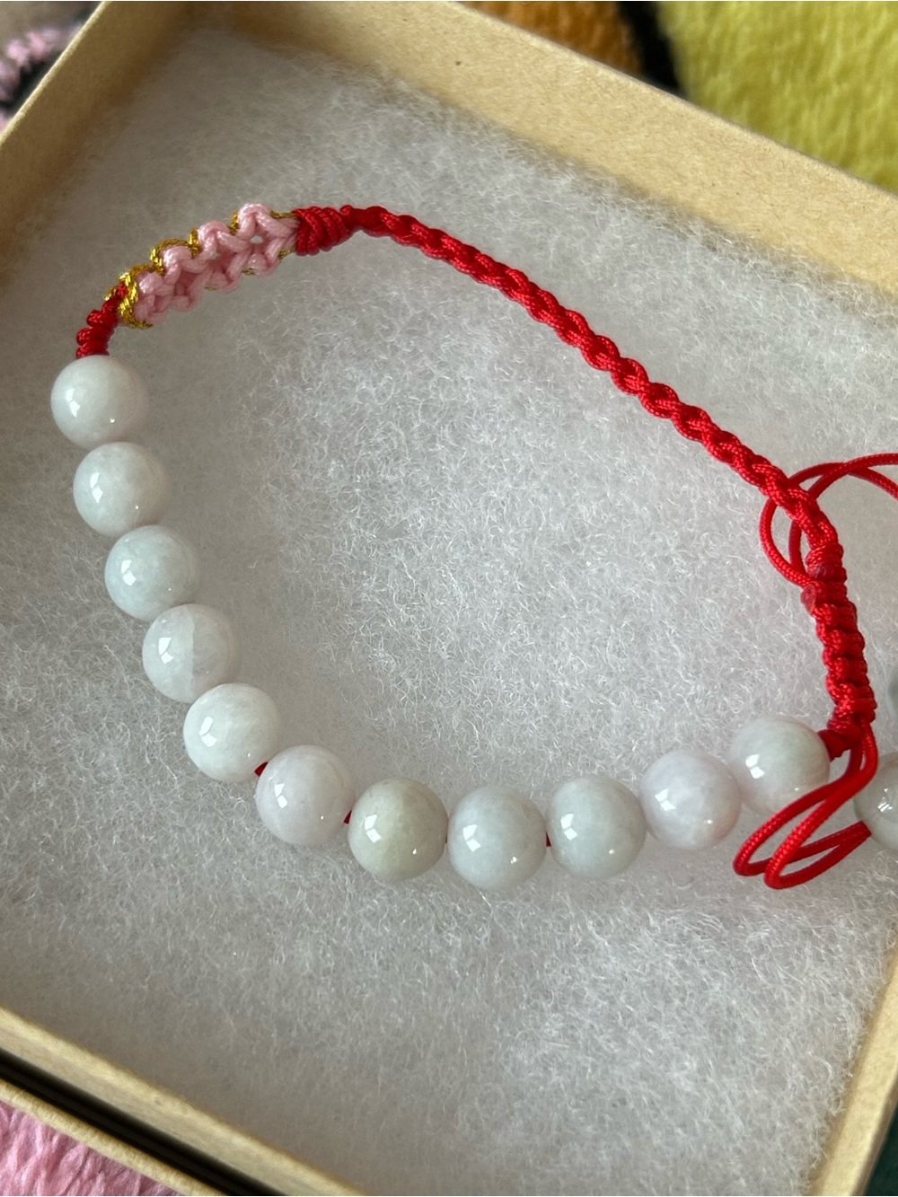White Jade Bead Bracelet with Red Cord and pink flowers